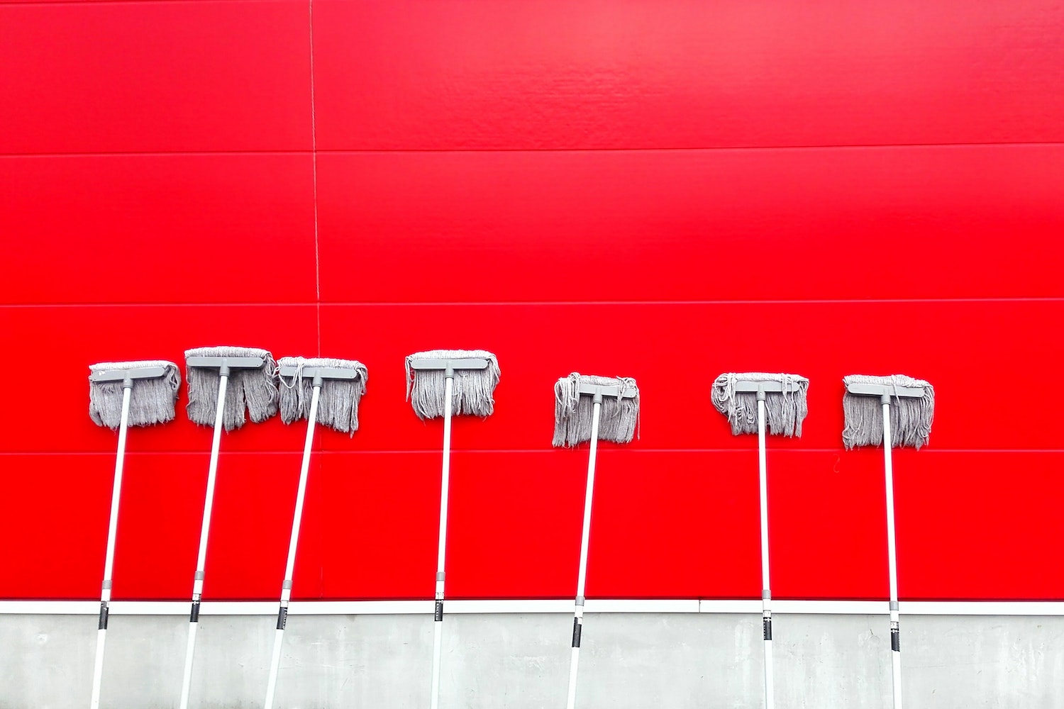 mops leaning against wall