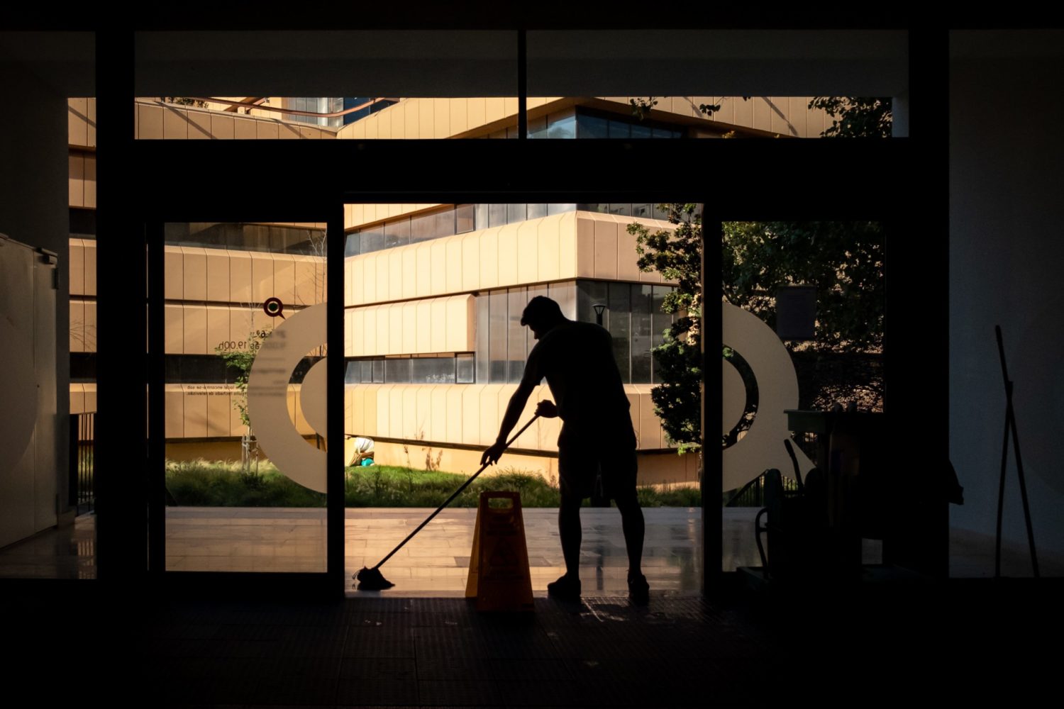 person cleaning floor of building