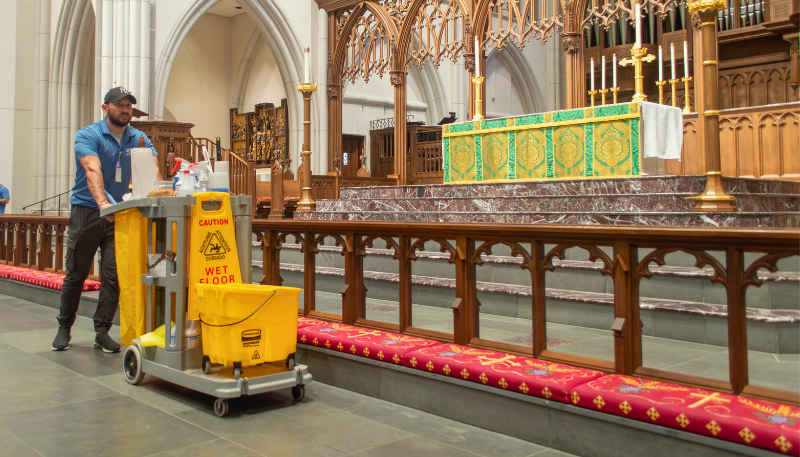 Janitor walking with cart in Methodist church.